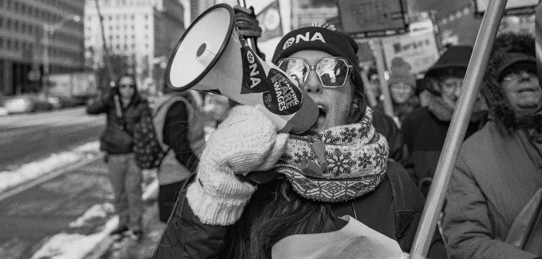 An ONA member during a rally, holding a megaphone