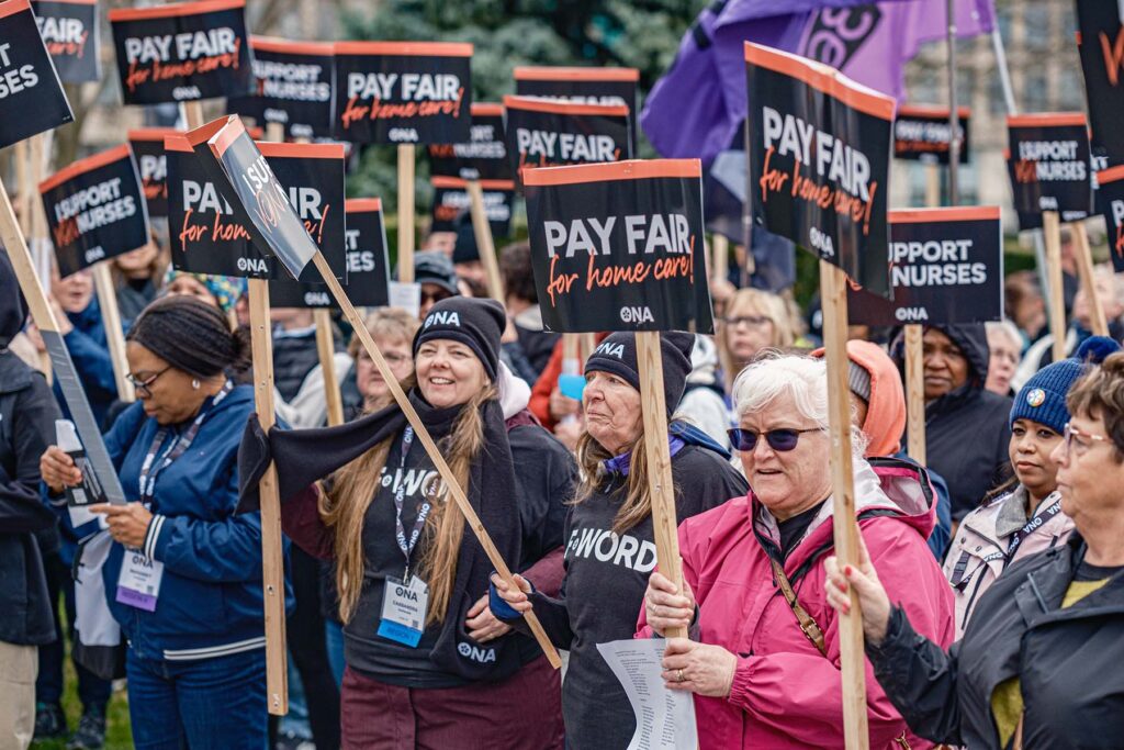 Group of members hold signs at rally.