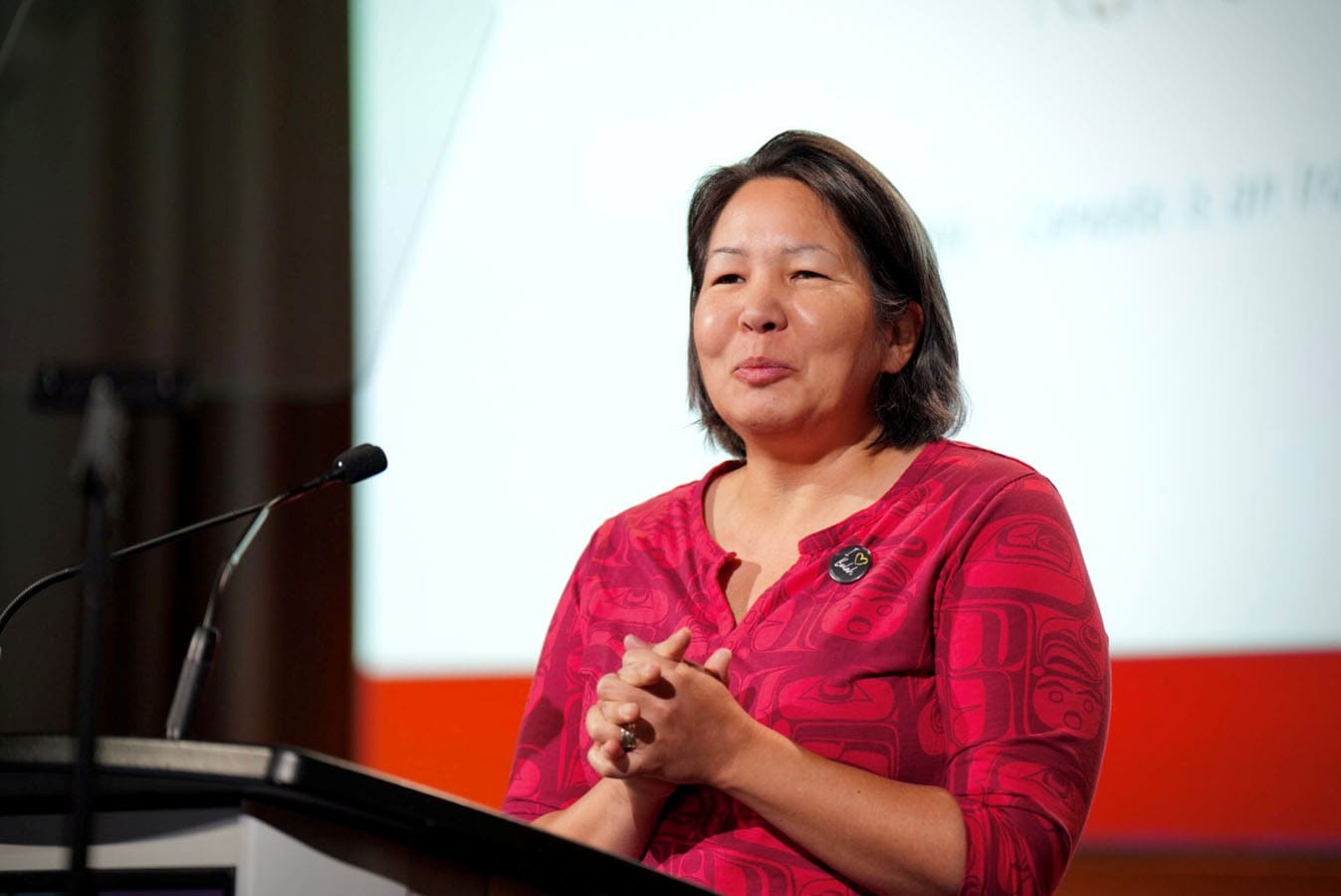 Rose Le May, our lead consultant of reconciliation, at podium talks to large gathering.