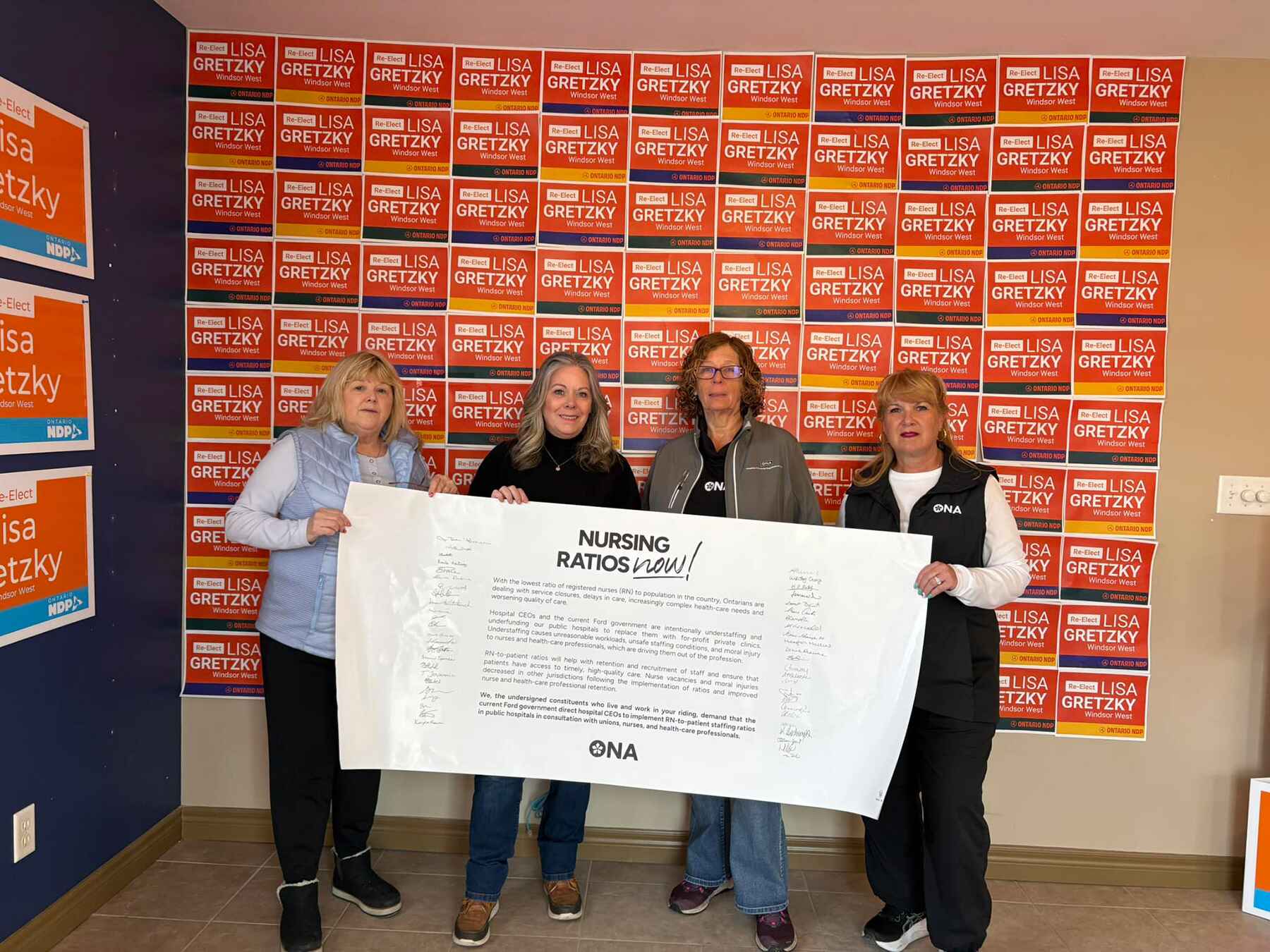 Three members stand with their local candidate.