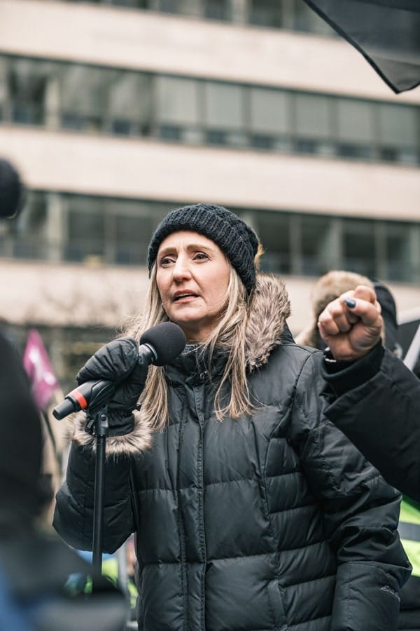 Ontario Federation of Labour President Laura Walton addresses crowd from flatbed truck.
