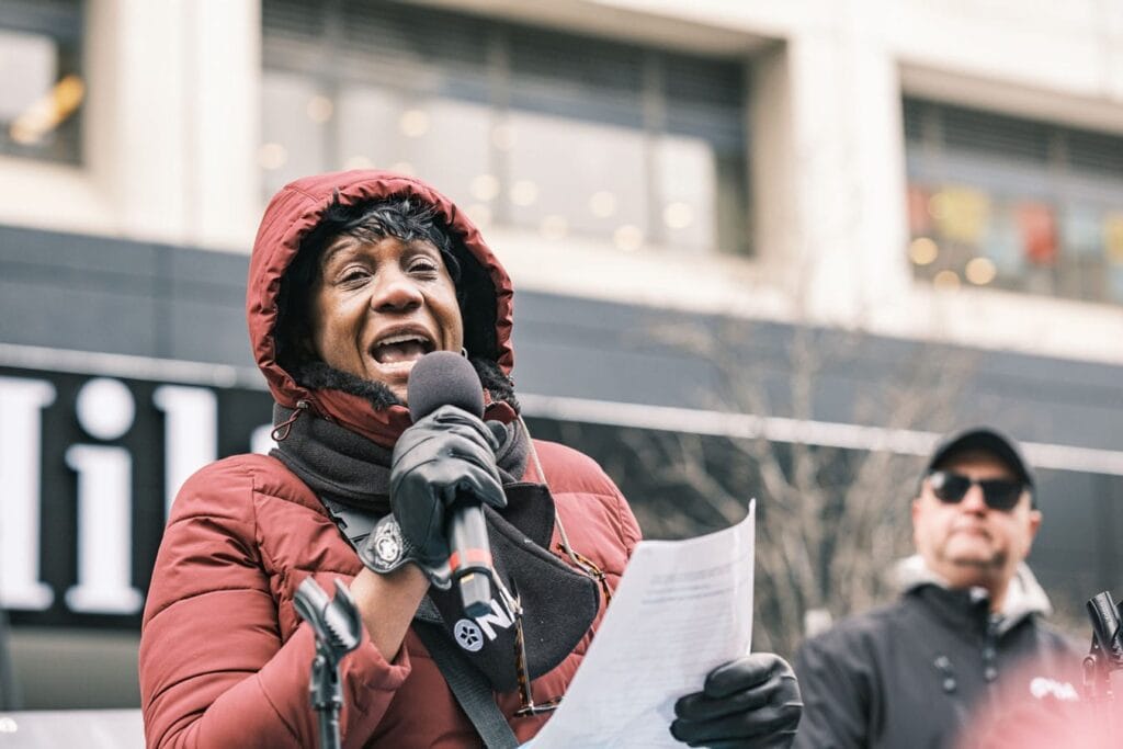 Member Marva McCalla reads notes from flatbed truck.