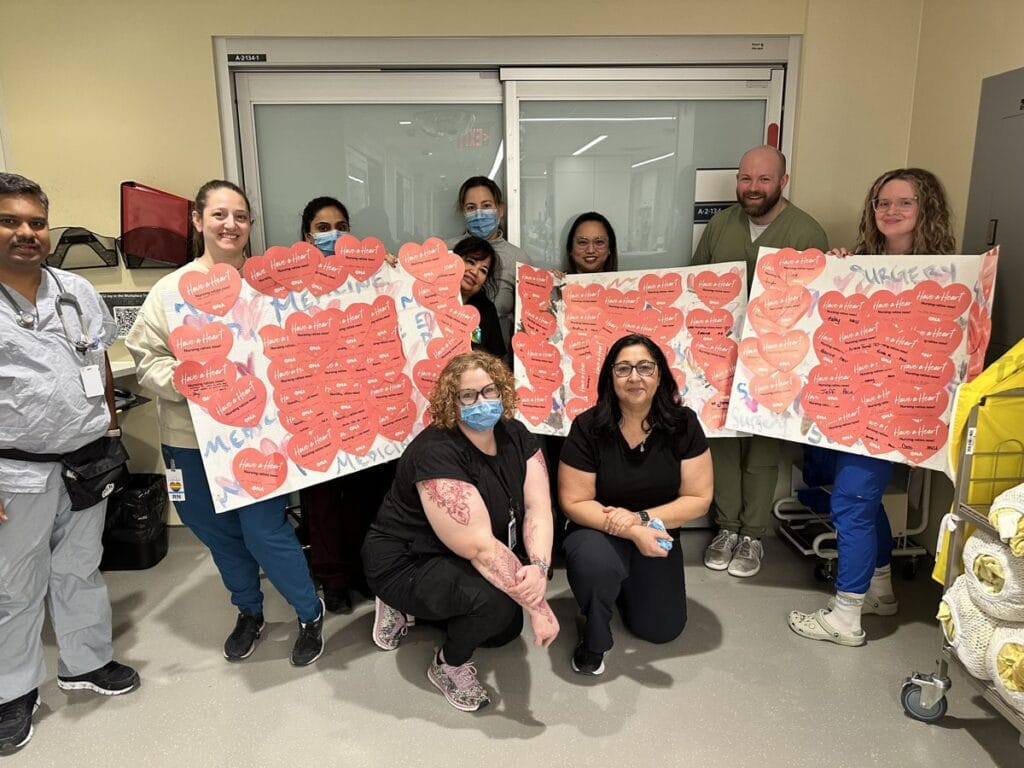 Group of members holding three Bristol boards full of valentines.