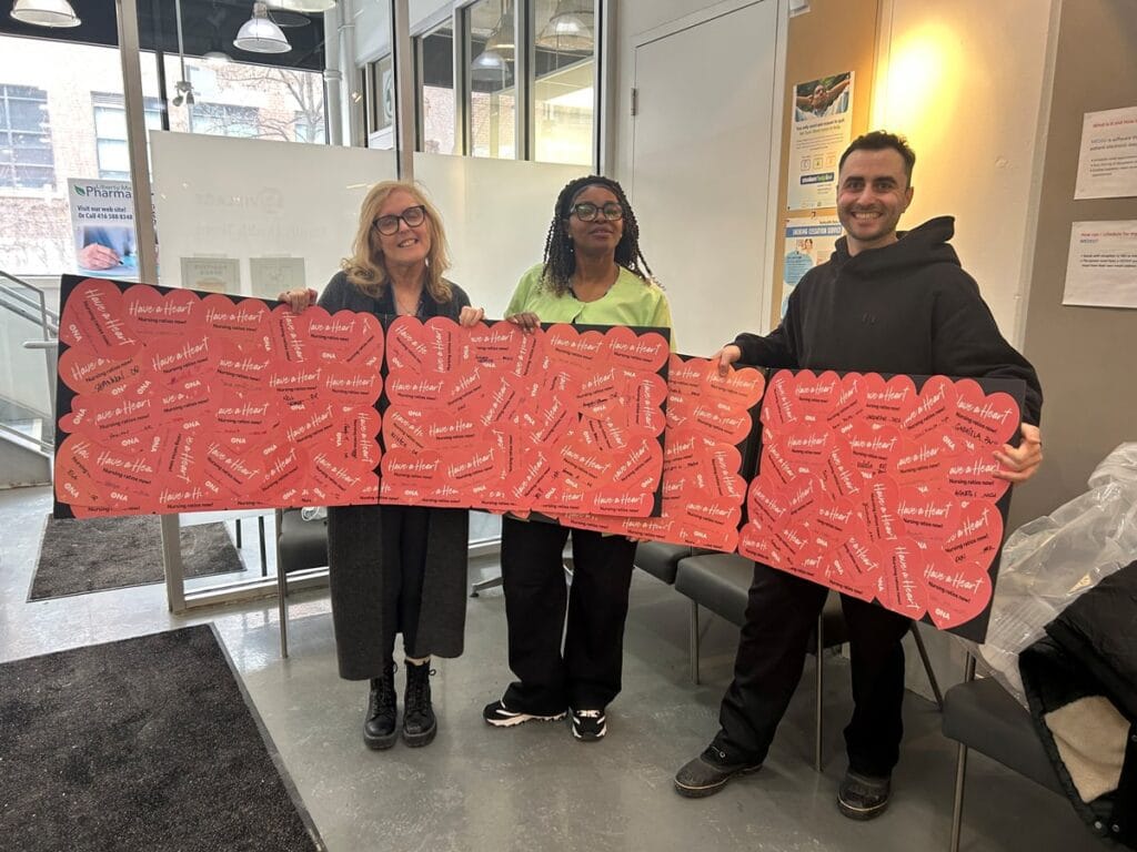 ONA95 Local Vice-Coordinator Maureen McLeod and two members hold three Bristol boards full of valentines.