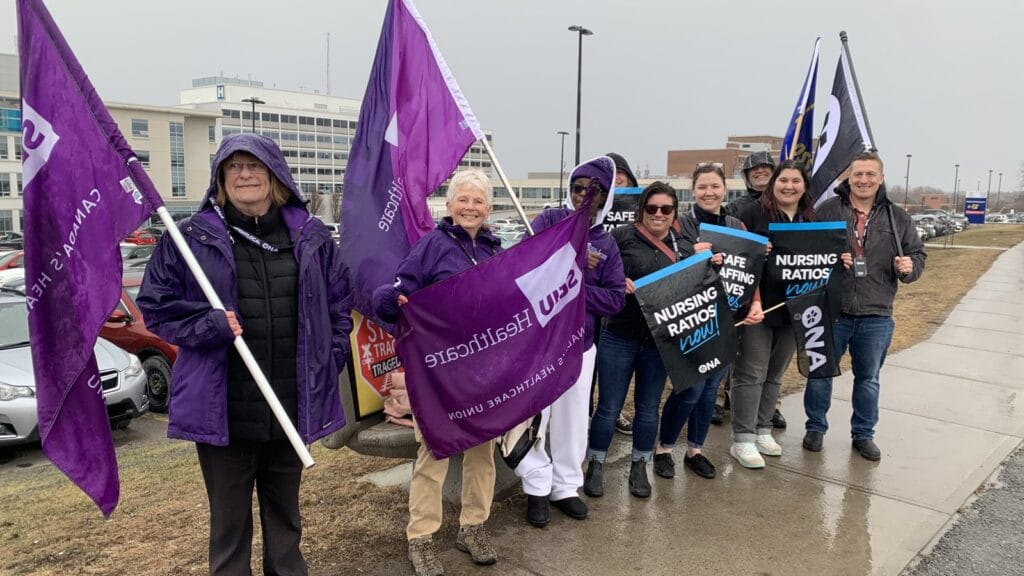 Members and allies hold union flags.