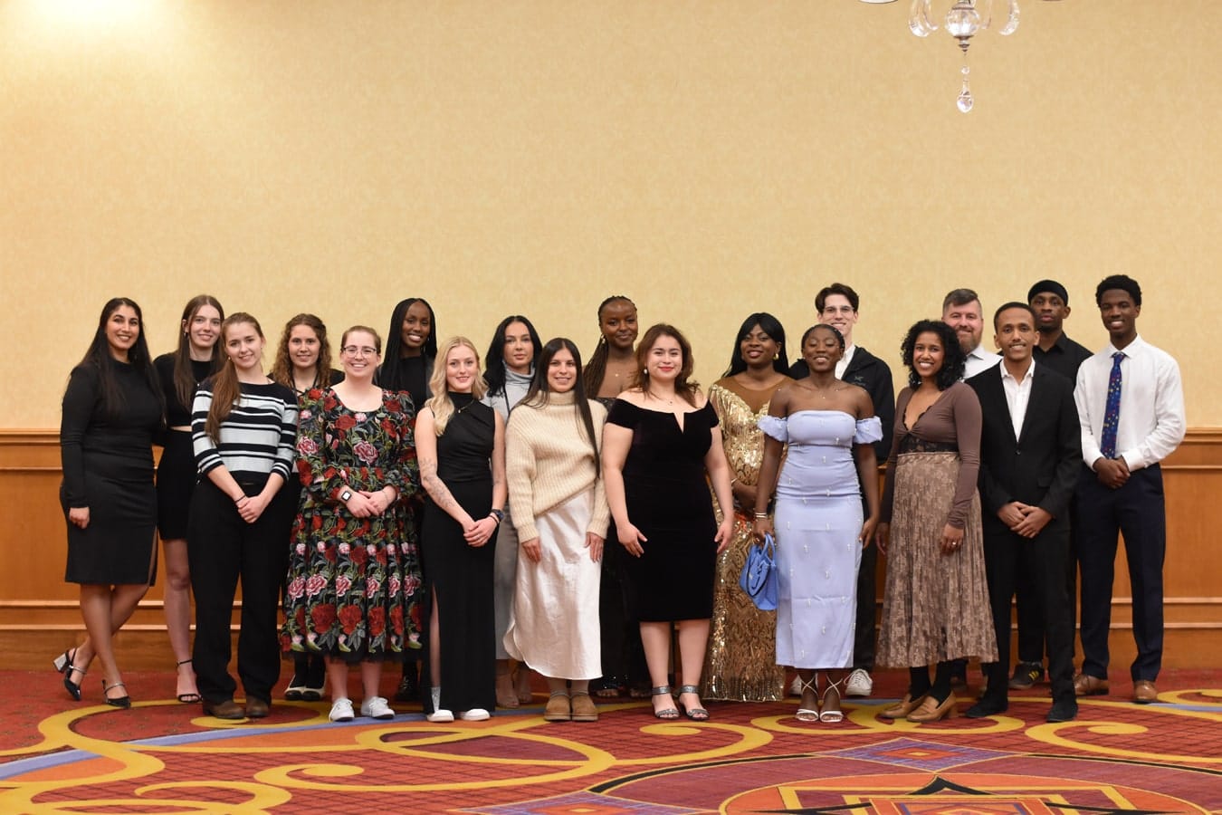 Smaller group of nursing students standing and smiling.