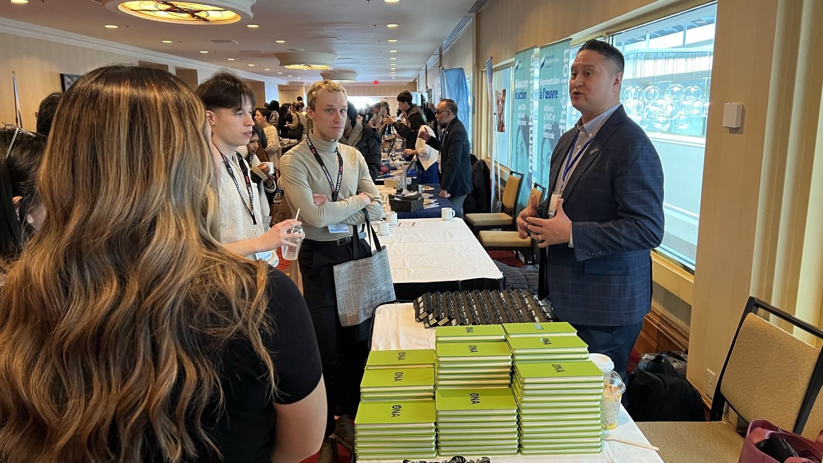 Region 5 Vice-President and then interim First Vice-President Alan Warrington hands out material to students from a table.