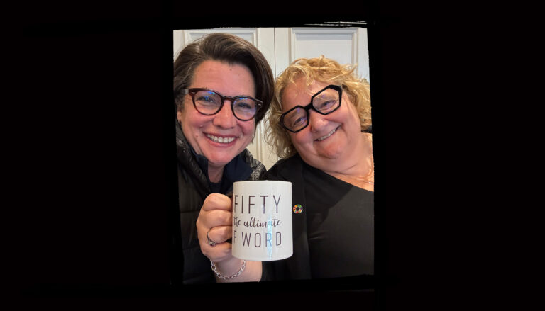 ONA President Erin Ariss and CEO Andrea Kay hold a mug reading, “Fifty is the ultimate f-word.”