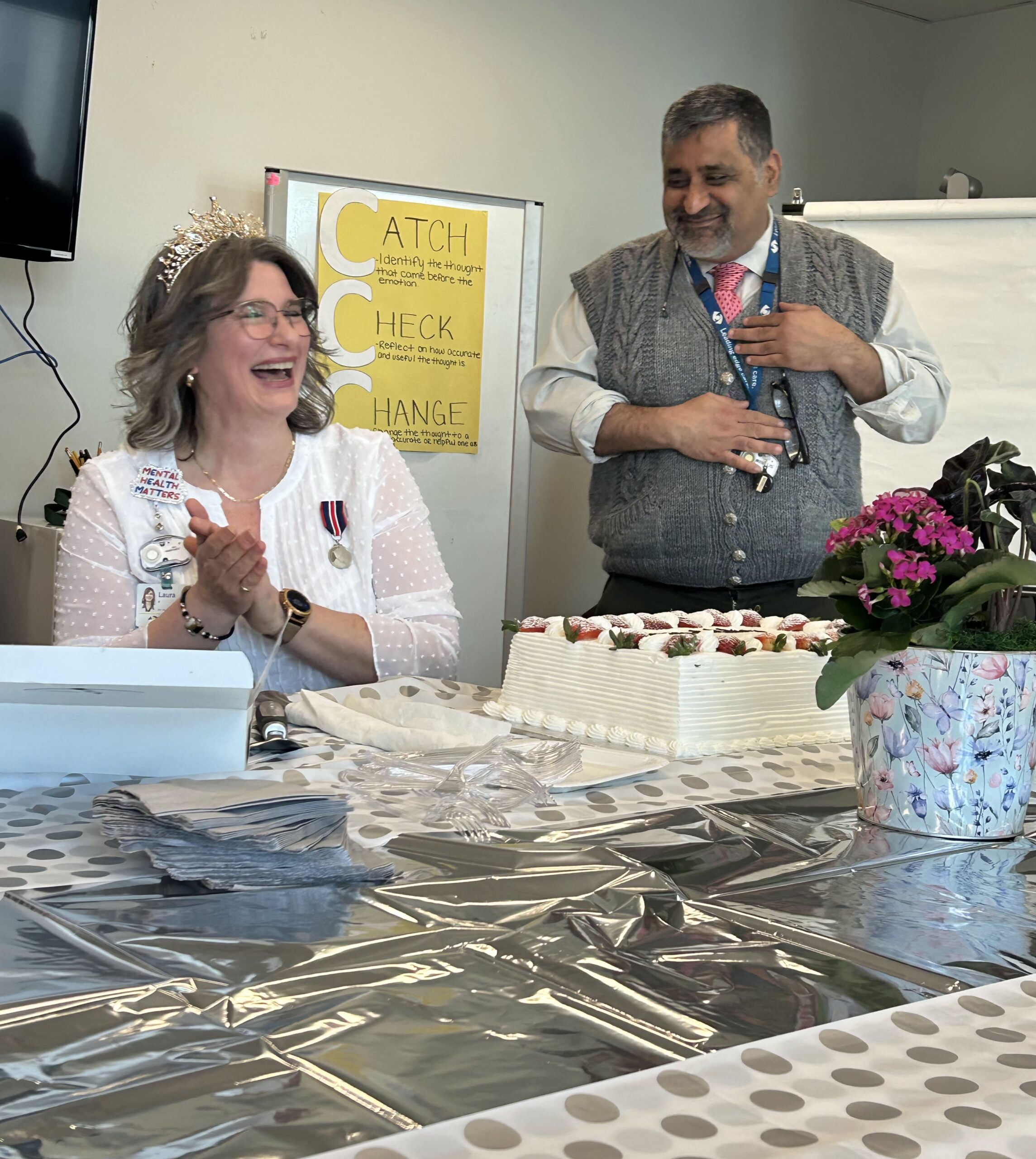 ONA member Laura Pella shares a laugh with Dr. Gaurav Mehta, who monitors most of her community treatment orders, at a celebration in honour of her King Charles III Coronation Medal for Nursing Excellence.