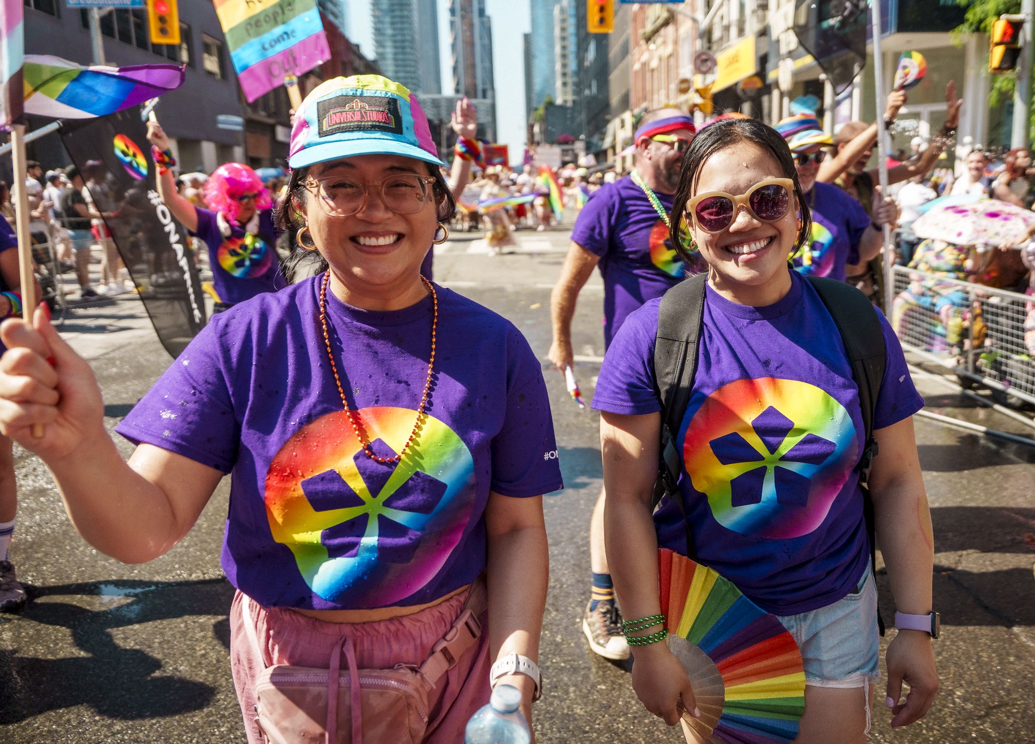 Two ONA members smiling and marching in the parade.