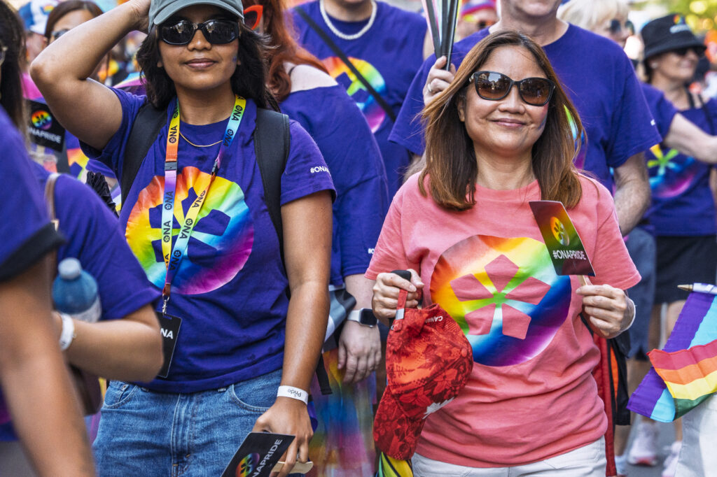 Two ONA members smile as they march in the parade.