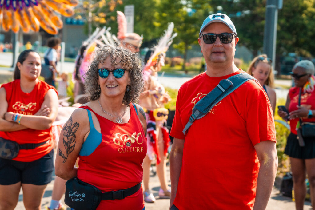 ONA board members Rachel Muir and Alan Warrington in matching red shirts that say 