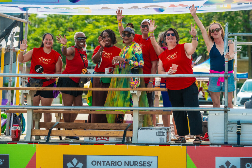 ONA board and staff members wave to the camera from the ONA Carnival float.
