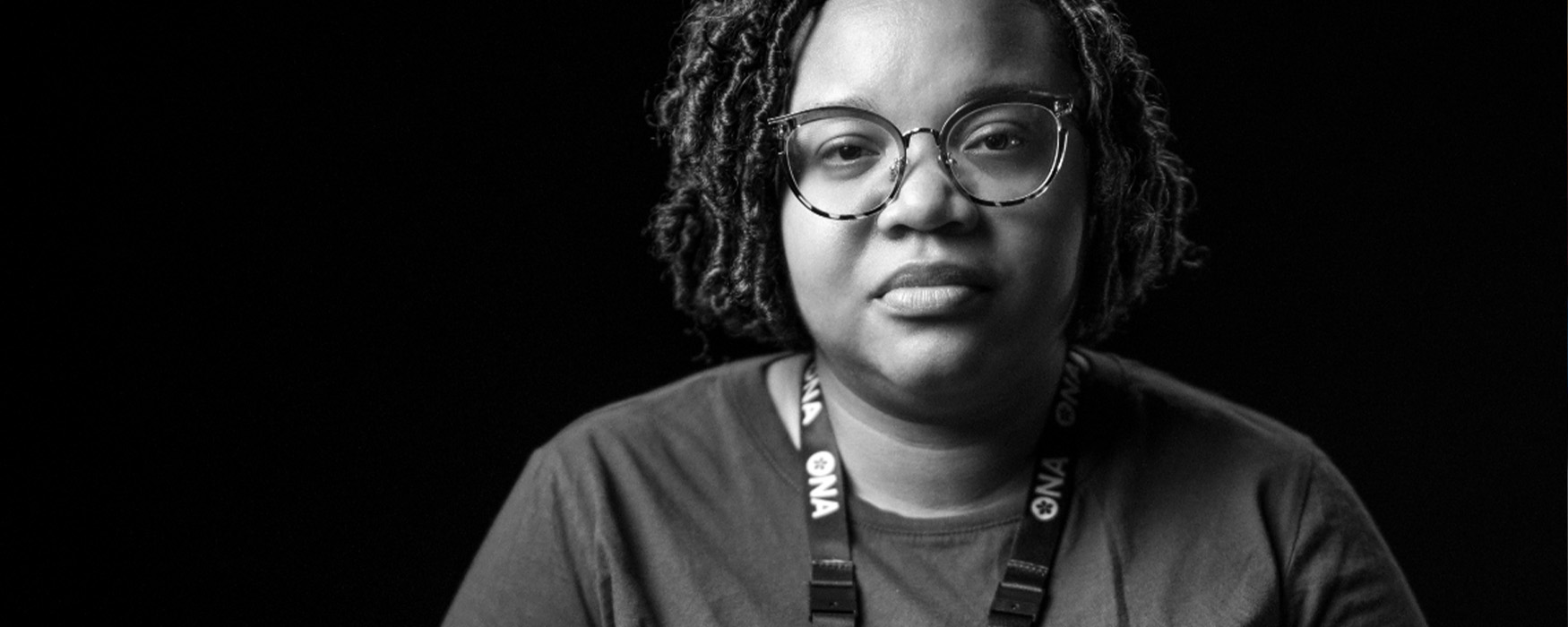 Black and white image of serious woman looking at the camera.