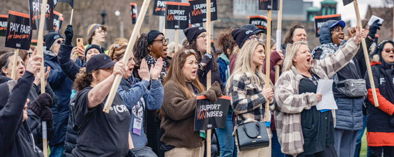 A group of members at a VON rally hold signs reading, “Pay Fair for Home Care.”