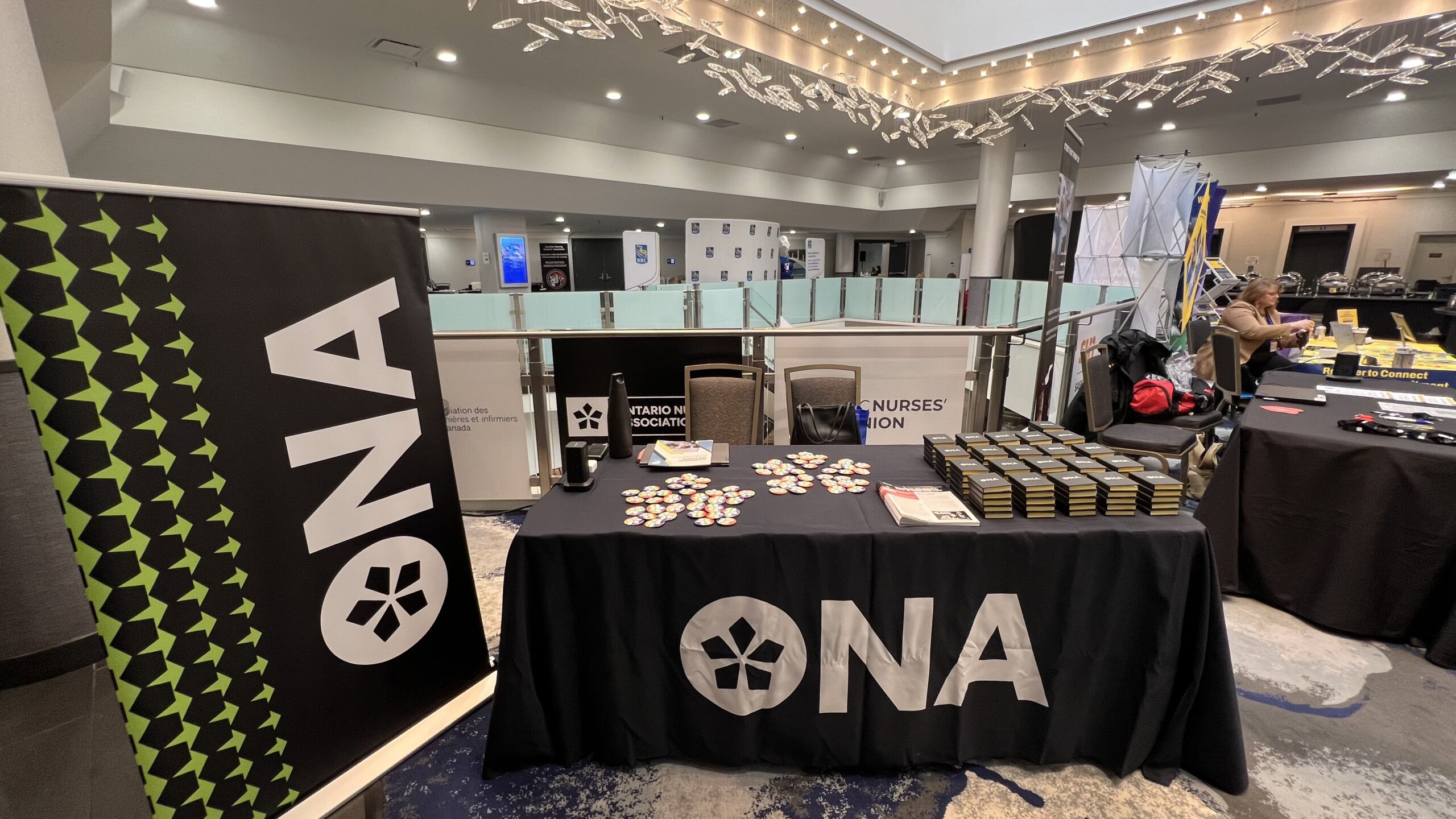 The ONA table at the CNSA National Conference displays ONA material and promotional items.