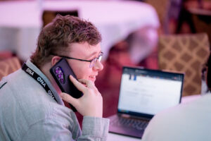 Man smiles while on phone.