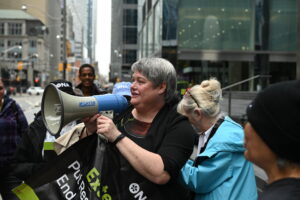 Woman speaks into megaphone.