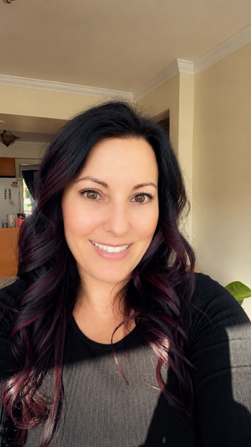 Headshot of woman with long dark hair.