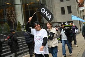 Member smiles while holding an ONA pennant.