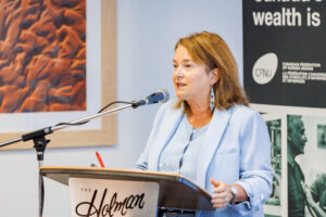 CFNU President Linda Silas speaks into a microphone at the podium.