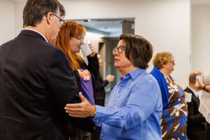 ONA Provincial President Erin Ariss puts her arm out while standing and talking to a man.