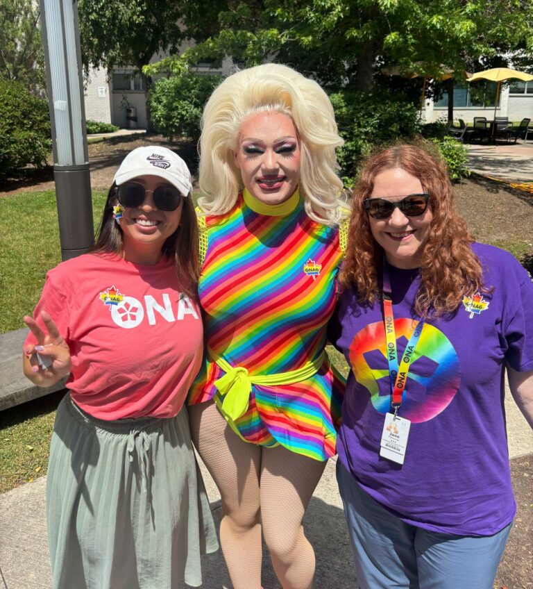 ONA6 Coordinator Jane Penciner and another member pose with drag queen, Baby Bel Bel.