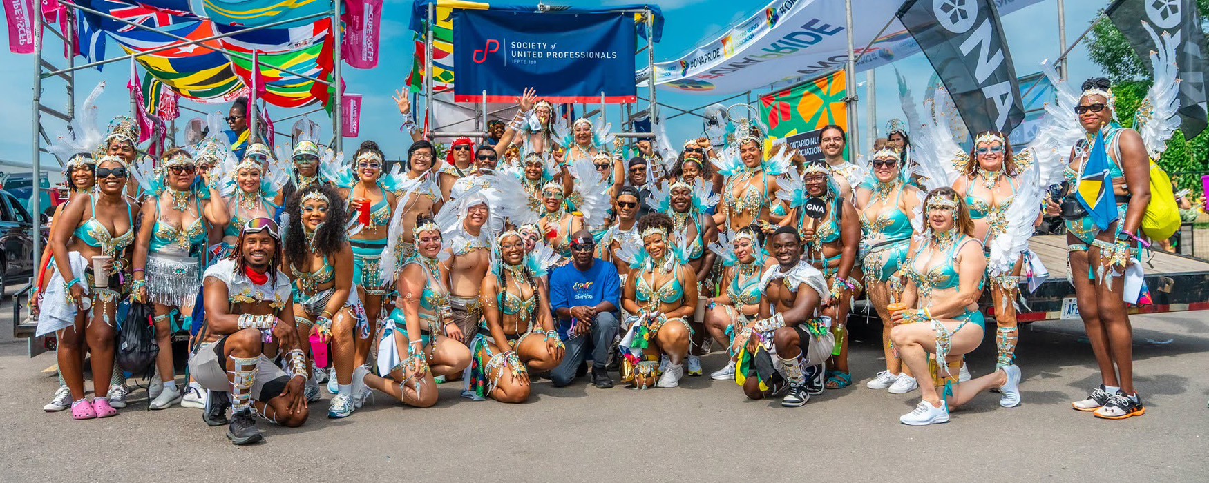 Large group shot of members dressed in colourful Toronto Caribbean Carnival costumes.