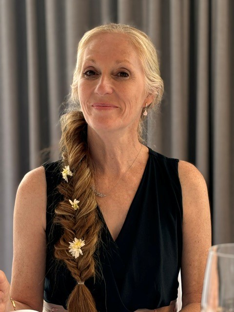 Headshot of Wendy Houston with long blond hair off to the side.