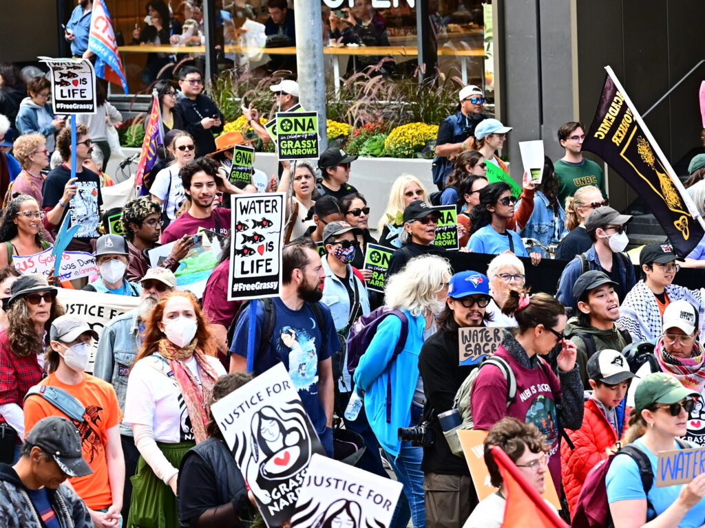 Closeup of the crowd on the street, showing ONA members.