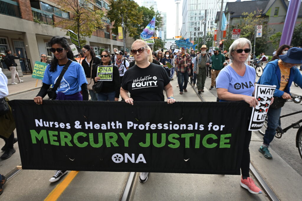 ONA members carry our banner through the streets.