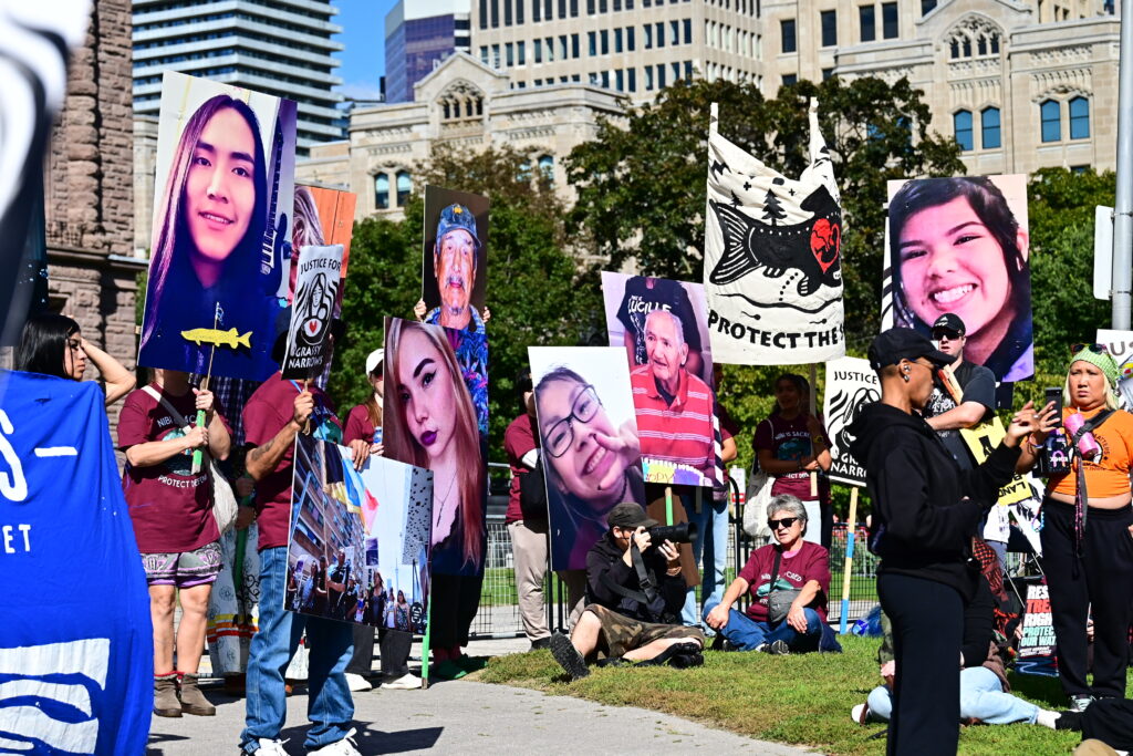 Photos of those who have died from mercury poisoning are displayed at Queen’s Park.