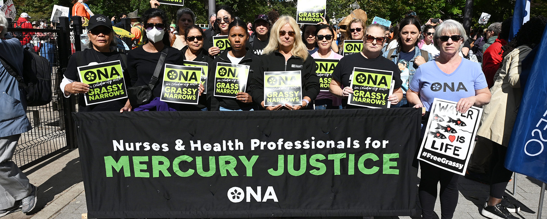 A group of ONA members and staff stand outside behind a banner that reads, “nurses and health-care professionals for mercury justice.”